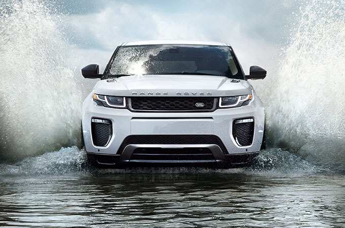 Range Rover Evoque wading through water front view.