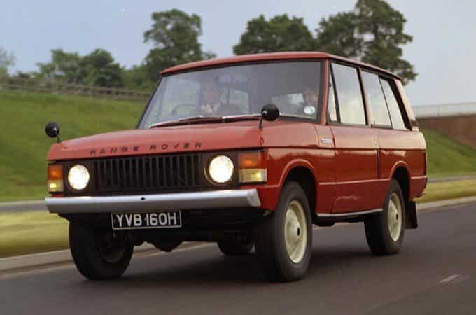 Range Rover Classic in red on country road front side view.