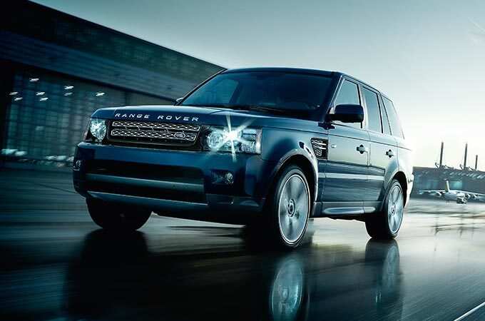 Range Rover Sport in motion on wet surface front side view.