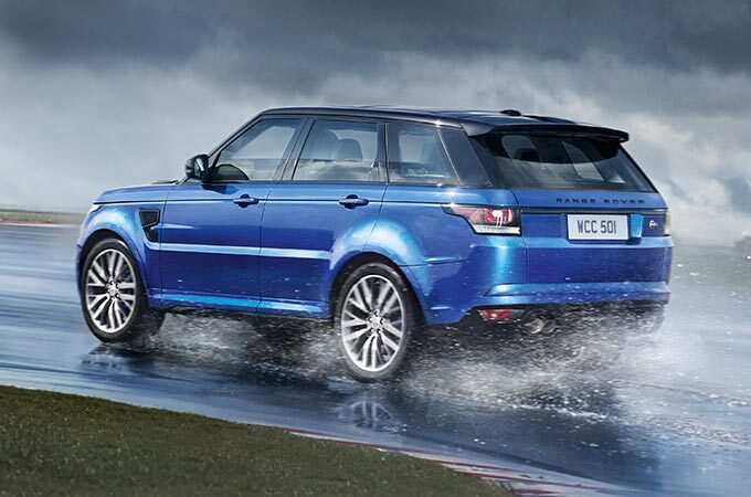 Range Rover Sport SVR in motion on wet surface rear side view.