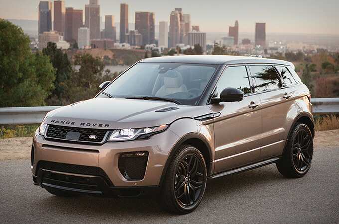 Range Rover Evoque on road with Los Angeles skyline in the background.