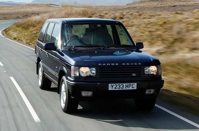 Second Generation Range Rover in motion on open road front side view.