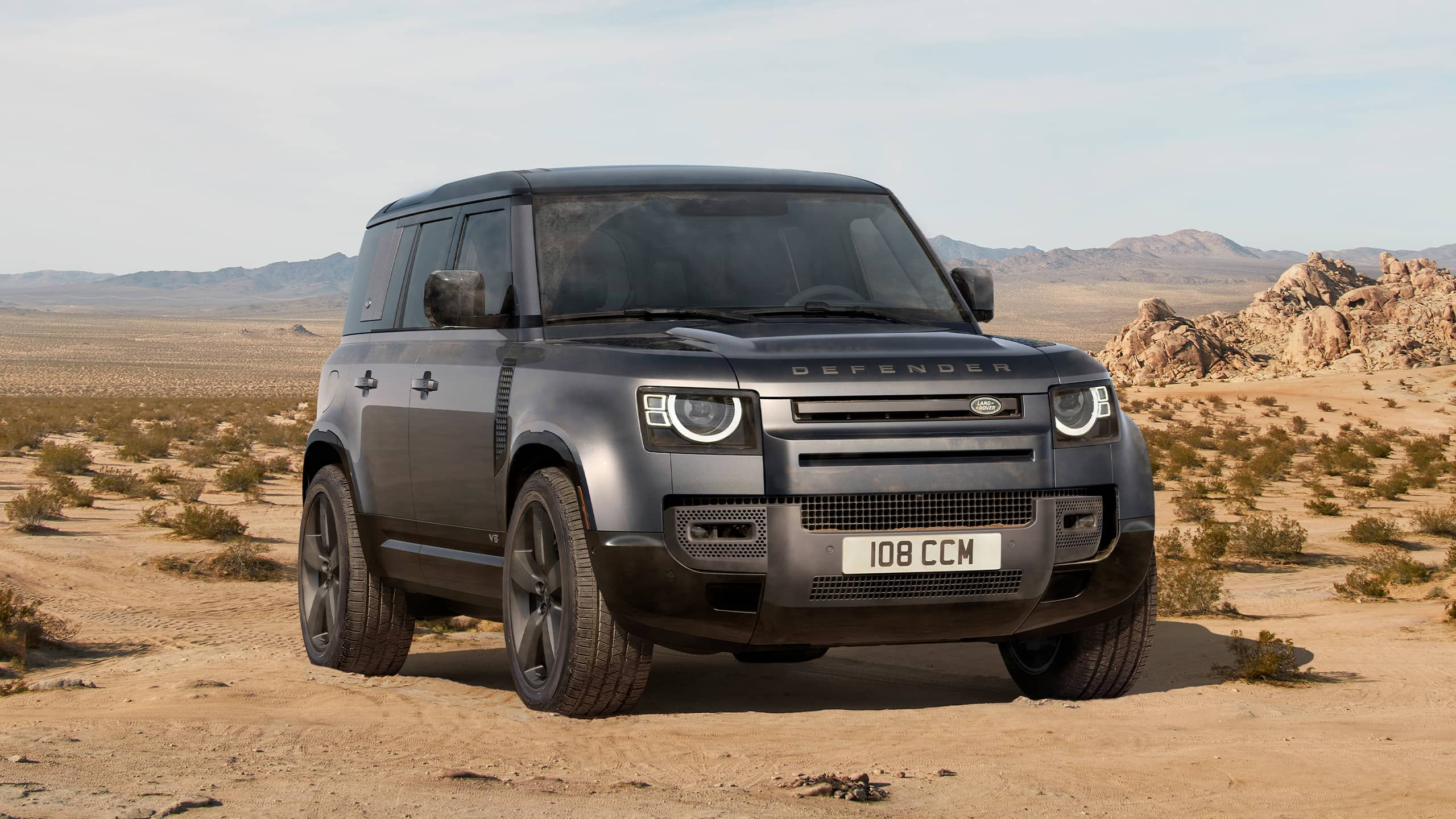 Defender Parked Over sand dust road