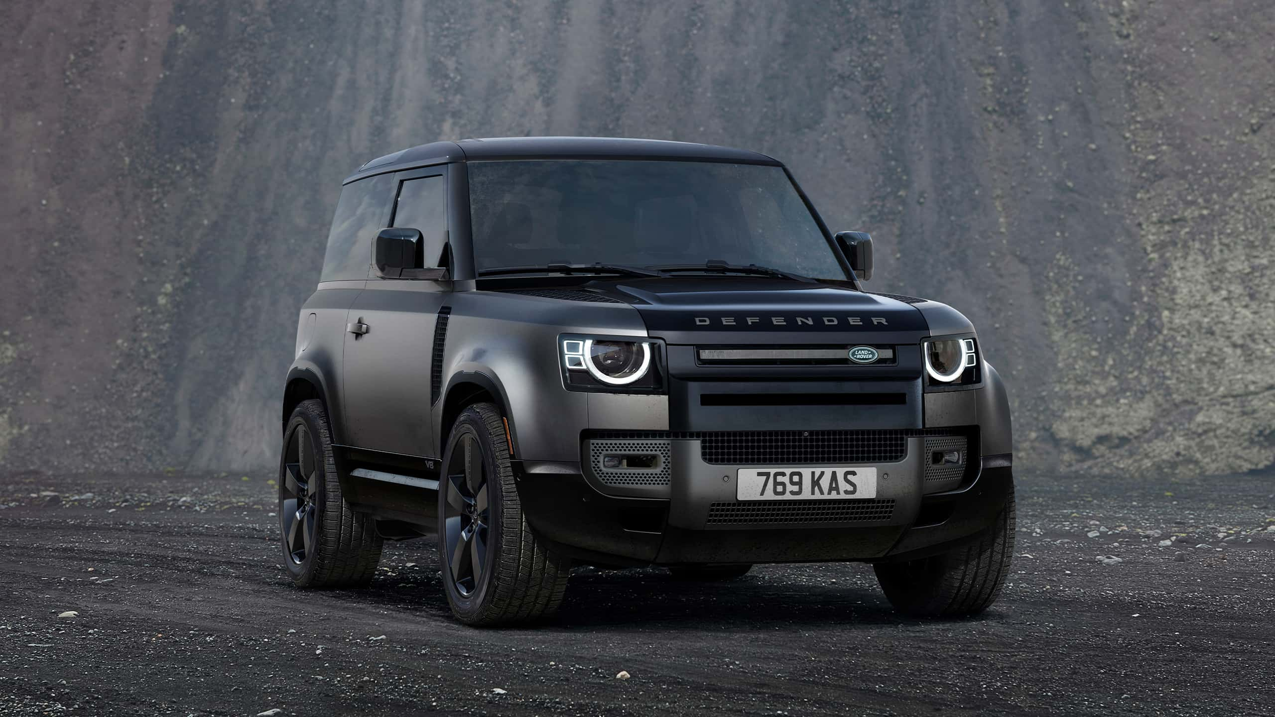 Defender Parked On Stone Road With A Mountain In Background