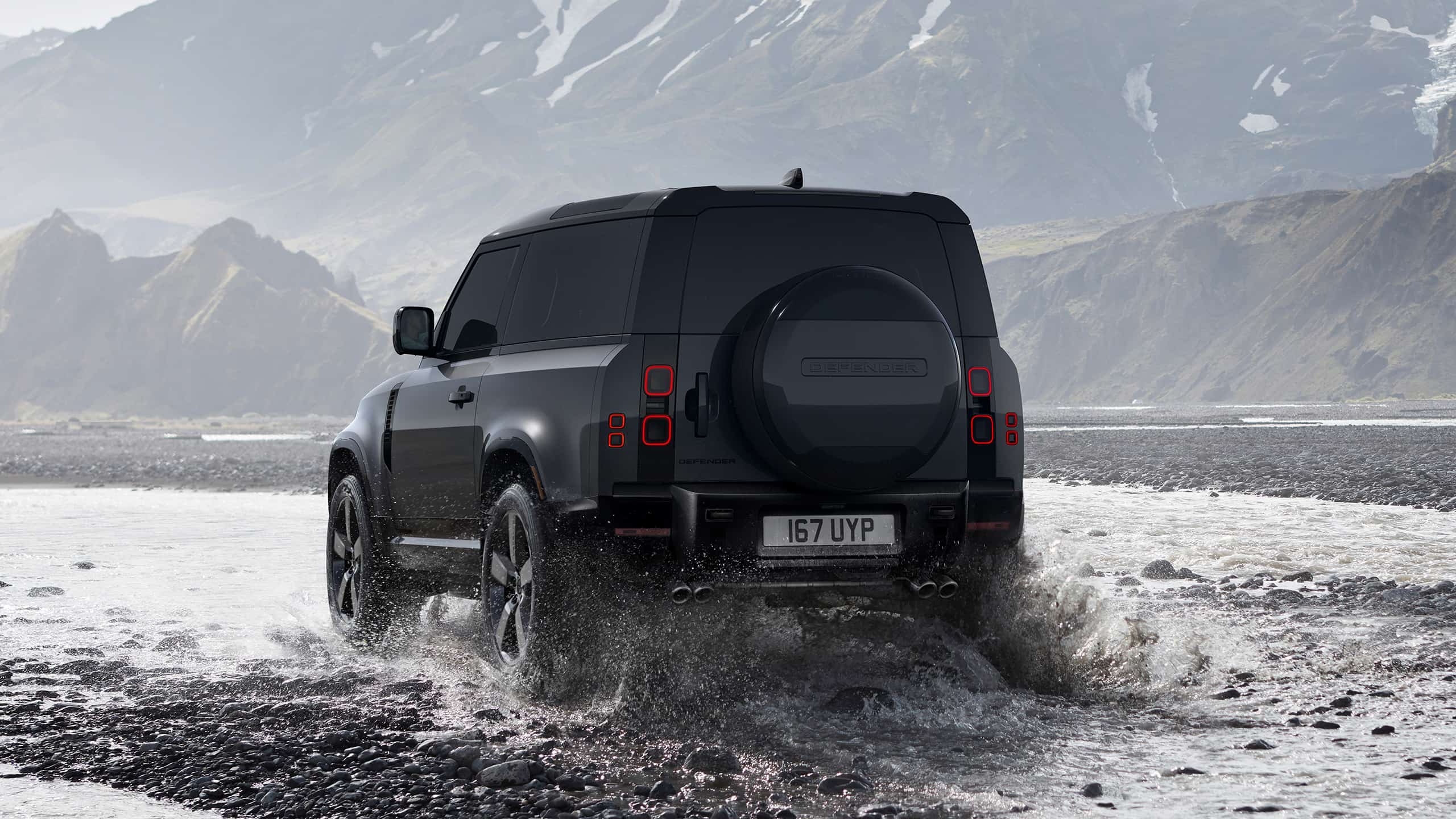 Defender is off roading in the mud of the river