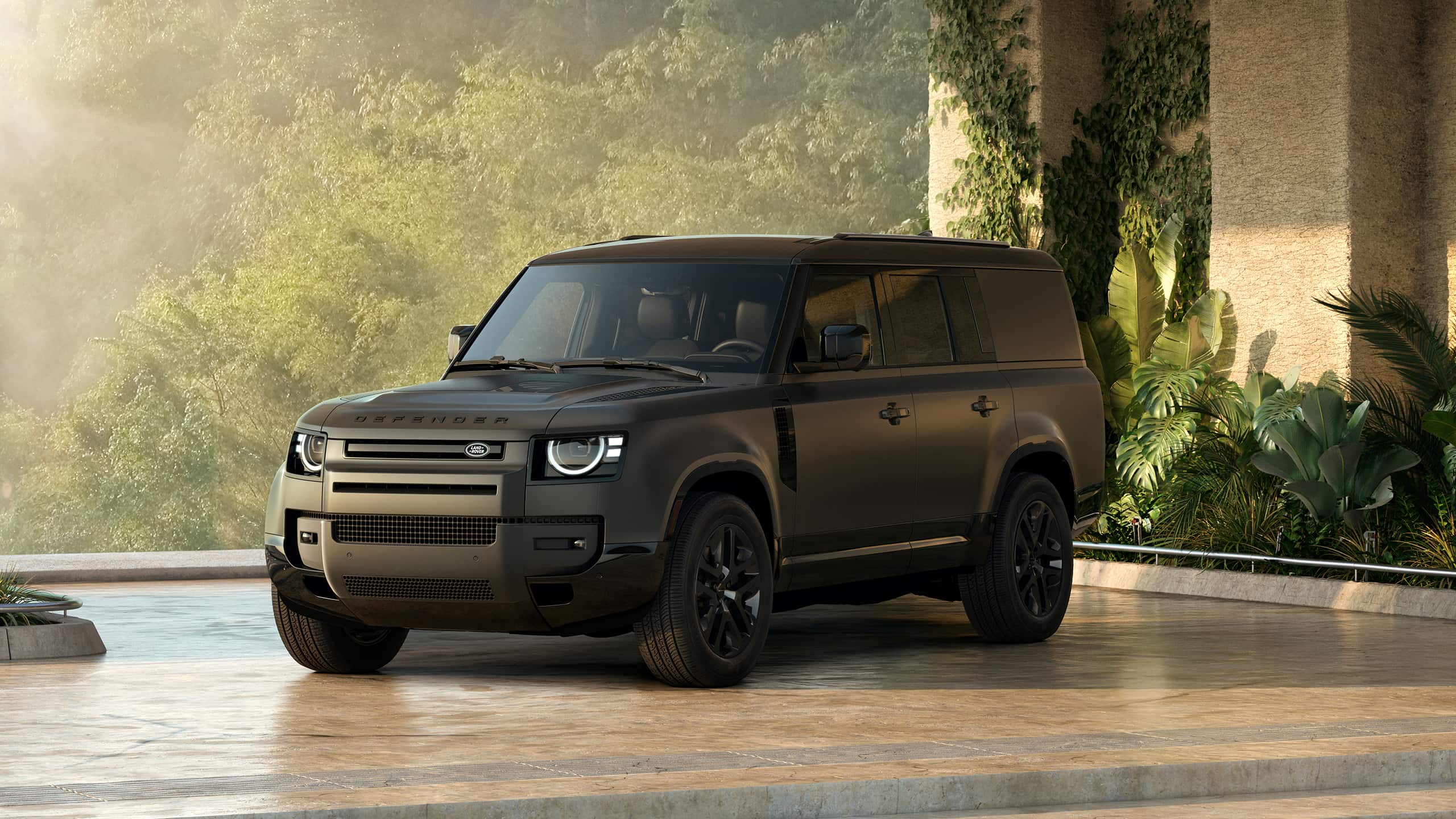 Black Defender parked in a modern outdoor setting.