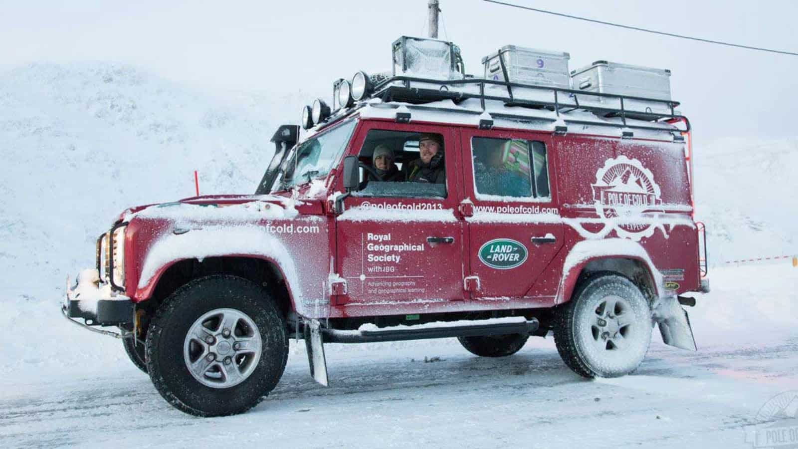 Land Rover Branded With The Royal Geographical Society Driving Through Snow