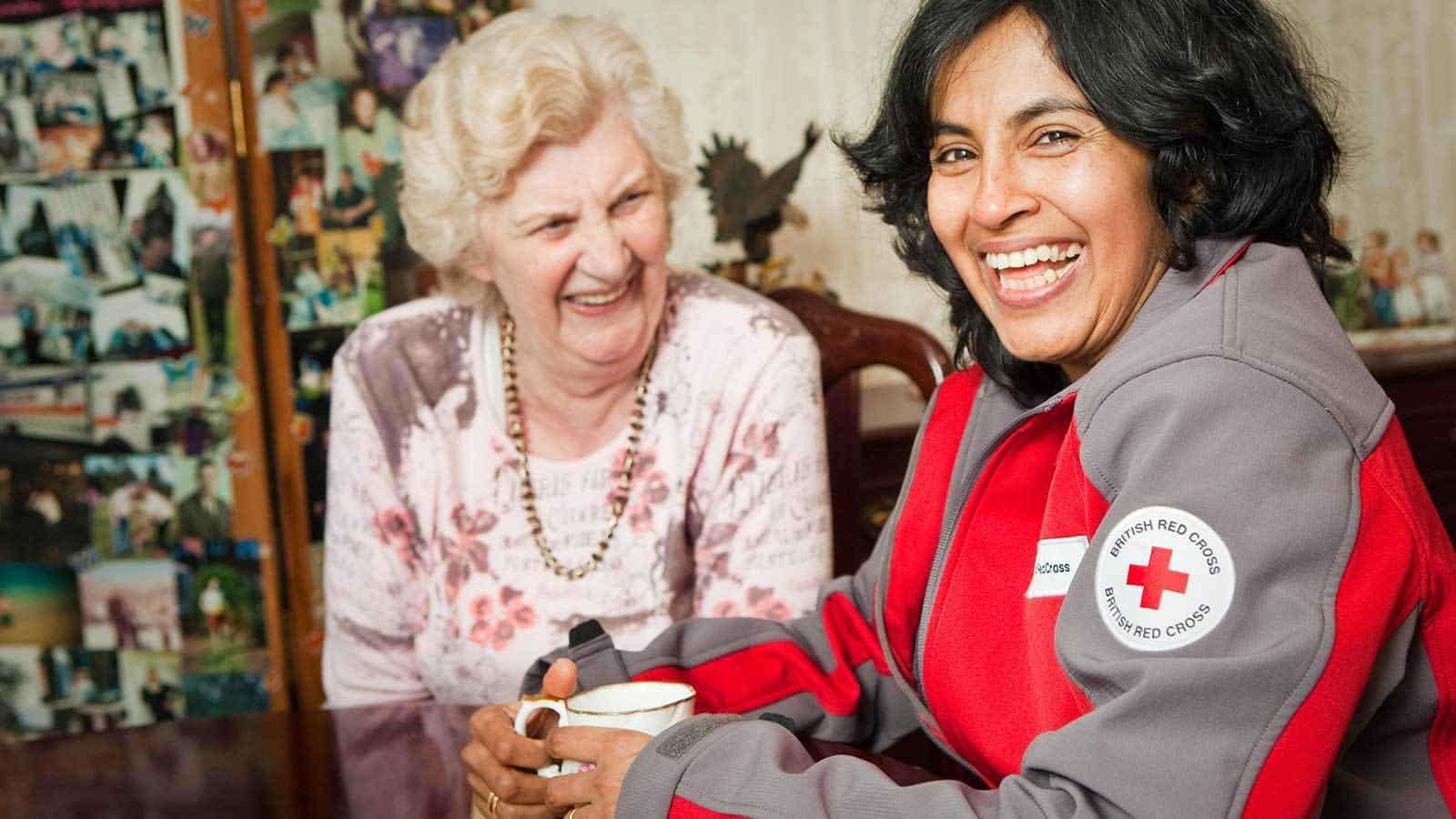 Female Representing British Red Cross Helping Vulnerable Elderly Female